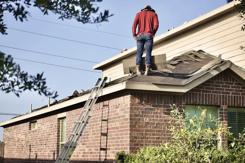 Professional roofer working on a residential roof in Marshall